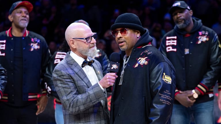 Allen Iverson, right, is interviewed by former team announcer Marc...