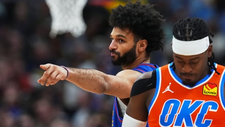 Denver Nuggets guard Jamal Murray, back, gestures as Oklahoma City...