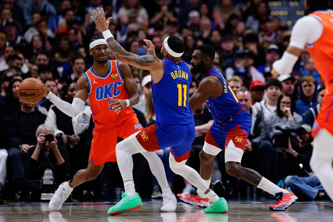 Feb 1, 2026; Denver, Colorado, USA; Oklahoma City Thunder guard Shai Gilgeous-Alexander (2) looks to pass the ball under pressure from Denver Nuggets guard Bruce Brown (11) and guard Tim Hardaway Jr. (10) in the fourth quarter at Ball Arena. Mandatory Credit: Isaiah J. Downing-Imagn Images