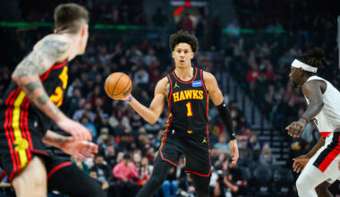Atlanta Hawks forward Jalen Johnson (1), center, dishes a pass to Atlanta Hawks guard Vit Krejci, left, during the first half of an NBA basketball game against the Portland Trail Blazers on Thursday, Jan. 15, 2026, in Portland, Ore. (AP Photo/Molly J. Smith)