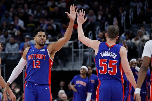 Detroit Pistons forward Tobias Harris (12) celebrates with forward Duncan Robinson (55) during the second half of an NBA basketball game against the Sacramento Kings, Sunday, Jan. 25, 2026, in Detroit. (AP Photo/Duane Burleson)