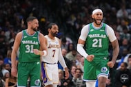 Dallas Mavericks forward Daniel Gafford (21) reacts after scoring a basket as teammate guard...