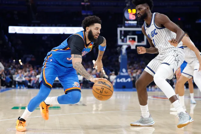 Feb 3, 2026; Oklahoma City, Oklahoma, USA; Oklahoma City Thunder guard/forward Kenrich Williams (34) drives to the basket against Orlando Magic forward Jonathan Isaac (1) during the second half at Paycom Center. Mandatory Credit: Alonzo Adams-Imagn Images