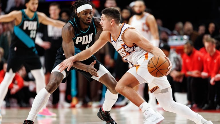Phoenix Suns guard Grayson Allen, right, dribbles against Portland Trail...