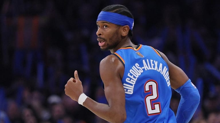 Oklahoma City Thunder guard Shai Gilgeous-Alexander looks back after making...