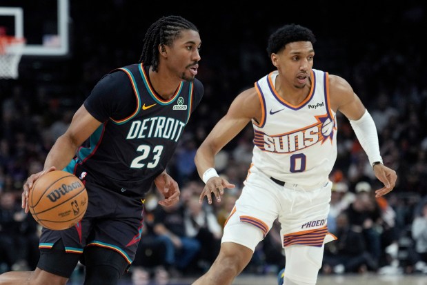 Pistons guard Jaden Ivey (23) dribbles past Suns forward Ryan Dunn during the first half on Jan. 29, 2026, in Phoenix. (AP Photo/Ross D. Franklin)