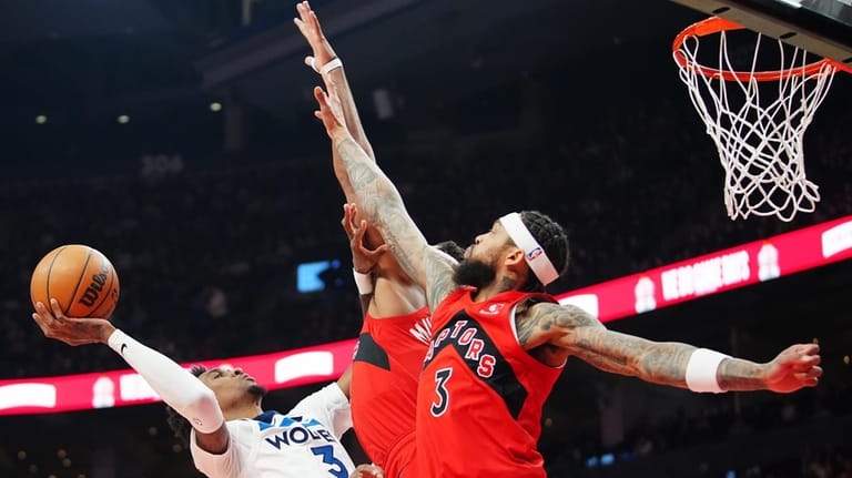 Minnesota Timberwolves' Jaden McDaniels (3) is fouled by Toronto Raptors'...