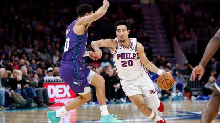 Philadelphia 76ers guard Jared McCain (20) drives against Charlotte Hornets...