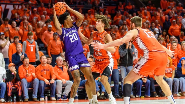 Illinois' Keaton Wagler (23) and Tomislav Ivisic (13) trap Northwestern's...