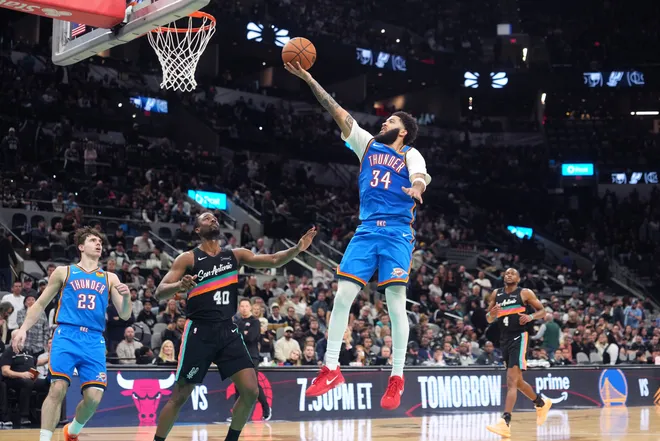 Feb 4, 2026; San Antonio, Texas, USA; Oklahoma City Thunder forward Kenrich Williams (34) drives to the basket against San Antonio Spurs forward Harrison Barnes (40) during the second half at Frost Bank Center. Mandatory Credit: Scott Wachter-Imagn Images