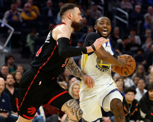 Golden State Warriors' Jonathan Kuminga (1) heads to the basket against Toronto Raptors' Sandro Mamukelashvili (54) in the fourth quarter at the Chase Center in San Francisco, Calif., on Tuesday, Jan. 20, 2026. (Nhat V. Meyer/Bay Area News Group)