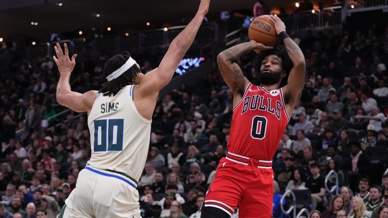 Chicago Bulls' Coby White shoots over Milwaukee Bucks' Jericho Sims...