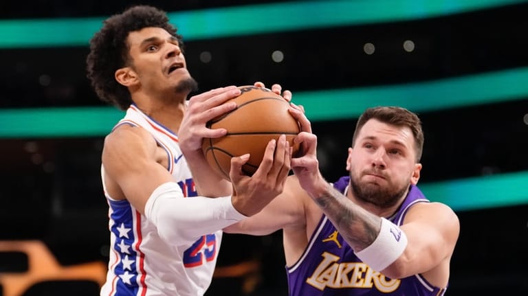 Philadelphia 76ers forward Dominick Barlow, left, and Los Angeles Lakers...