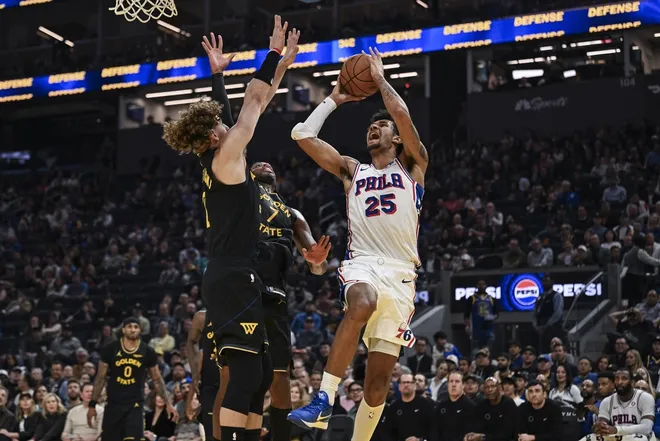 Feb 3, 2026; San Francisco, California, USA; Philadelphia 76ers forward Dominick Barlow (25) shoots over Golden State Warriors guard Brandin Podziemski (2) during the second period at Chase Center.