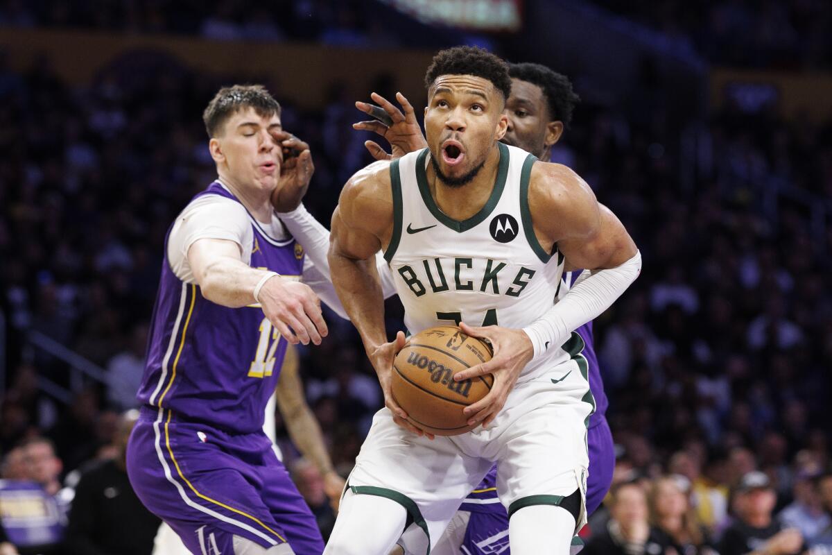 Bucks forward Giannis Antetokounmpo gathers the ball as he prepares to attempt a shot against the Lakers last month.