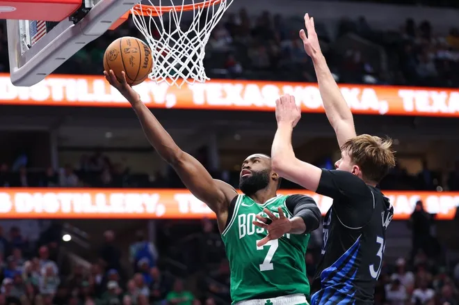 Feb 3, 2026; Dallas, Texas, USA; Boston Celtics guard Jaylen Brown (7) shoots past Dallas Mavericks forward Cooper Flagg (32) during the second half at American Airlines Center.