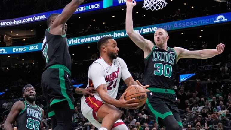 Miami Heat guard Norman Powell (24) is pressured by Boston...