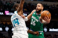 Dallas Mavericks forward Caleb Martin (16) tries to shoot over Charlotte Hornets forward...