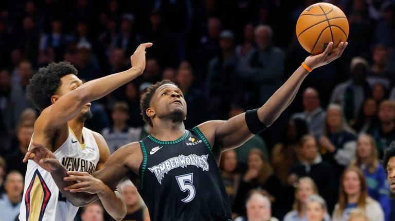 Minnesota Timberwolves guard Anthony Edwards (5) goes to the basket...
