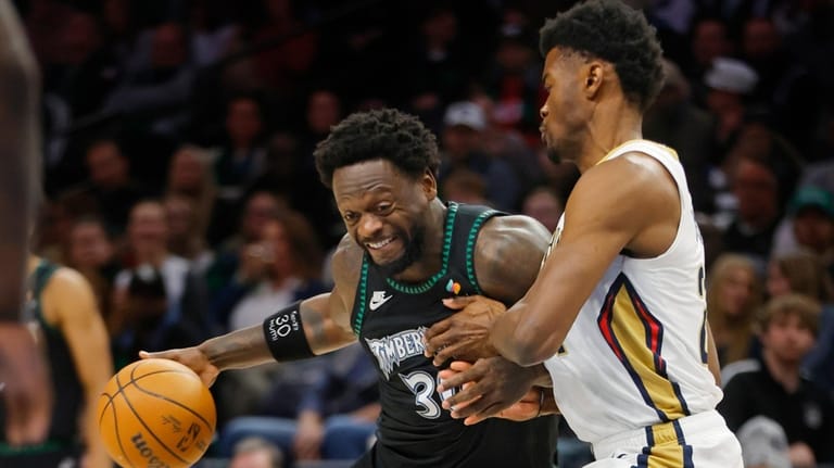 Minnesota Timberwolves forward Julius Randle, left, works against New Orleans...