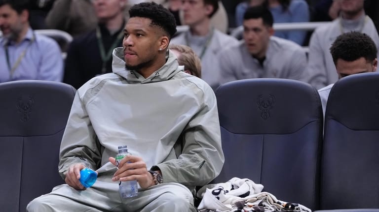 Milwaukee Bucks' Giannis Antetokounmpo watches from the bench during the...