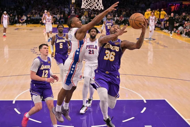 Feb 5, 2026; Los Angeles, California, USA; Los Angeles Lakers guard Marcus Smart (36) drives past Philadelphia 76ers guard Tyrese Maxey (0) in the second half at Crypto.com Arena.