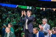 Former Dallas Maverick player Dirk Nowitzki applaudes Mark Aguirre during his jersey...