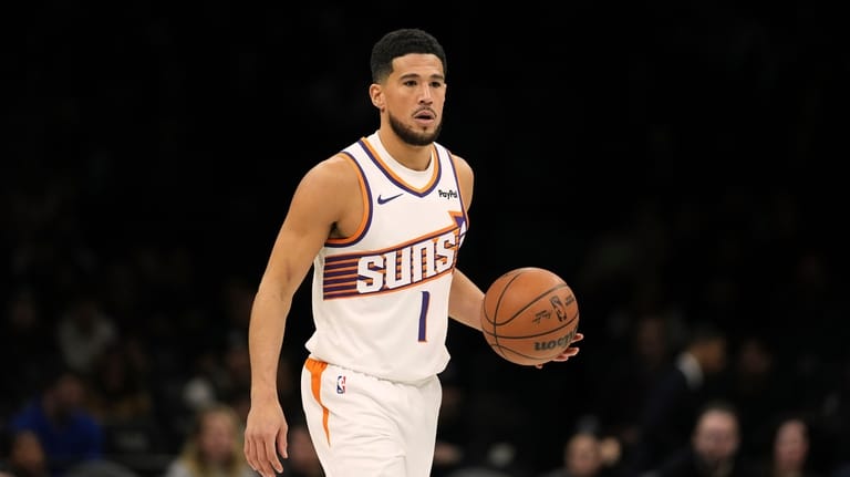 Phoenix Suns' Devin Booker (1) looks to pass during the...