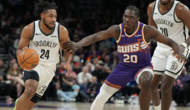 Brooklyn Nets guard Cam Thomas (24) drives on Phoenix Suns forward Rasheer Fleming (20) during the first half of an NBA basketball game, Tuesday, Jan. 27, 2026, in Phoenix. (AP Photo/Rick Scuteri)
