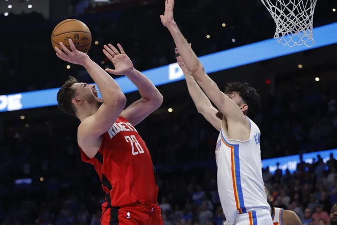Feb 7, 2026; Oklahoma City, Oklahoma, USA; Houston Rockets center Alperen Sengun (28) shoots as Oklahoma City Thunder center/forward Chet Holmgren (7) defends during the second half at Paycom Center.