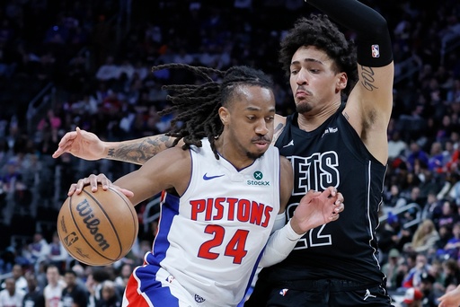Detroit Pistons guard Daniss Jenkins (24) drives against Brooklyn Nets forward Jalen Wilson, right, 22, during the second half of an NBA basketball game Sunday, Feb. 1, 2026, in Detroit. (AP Photo/Duane Burleson)