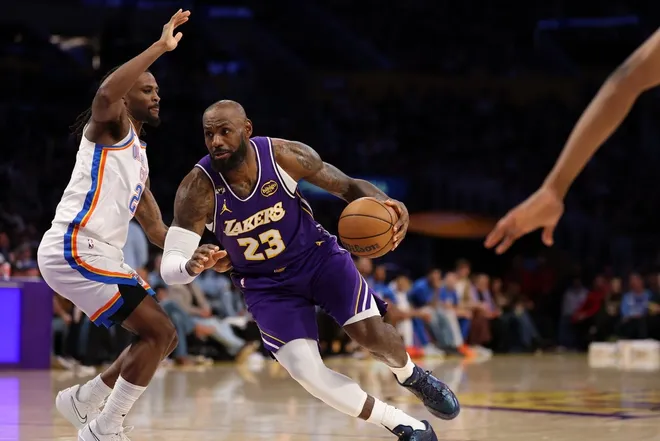 Feb 9, 2026; Los Angeles, California, USA; Los Angeles Lakers forward LeBron James (23) drives to the basket against Oklahoma City Thunder guard Cason Wallace (22) during the third quarter at Crypto.com Arena.