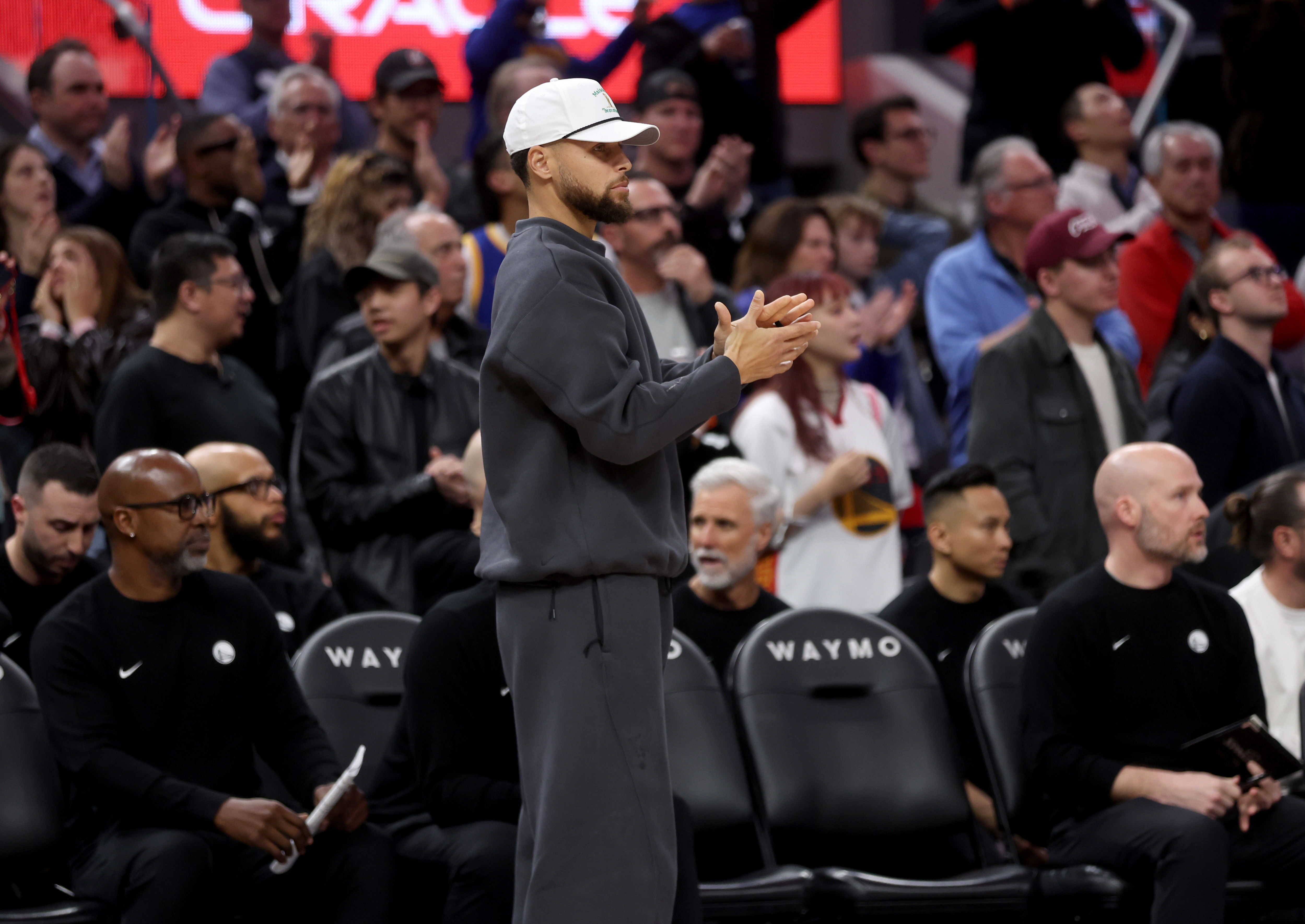 Golden State Warriors’ Stephen Curry #30 cheers from the bench...