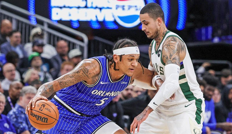 Paolo Banchero (5) drives against Milwaukee Bucks forward Kyle Kuzma (18) during the first quarter at Kia Center.