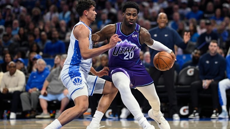 Utah Jazz center Jaren Jackson Jr. (20) is defended by...