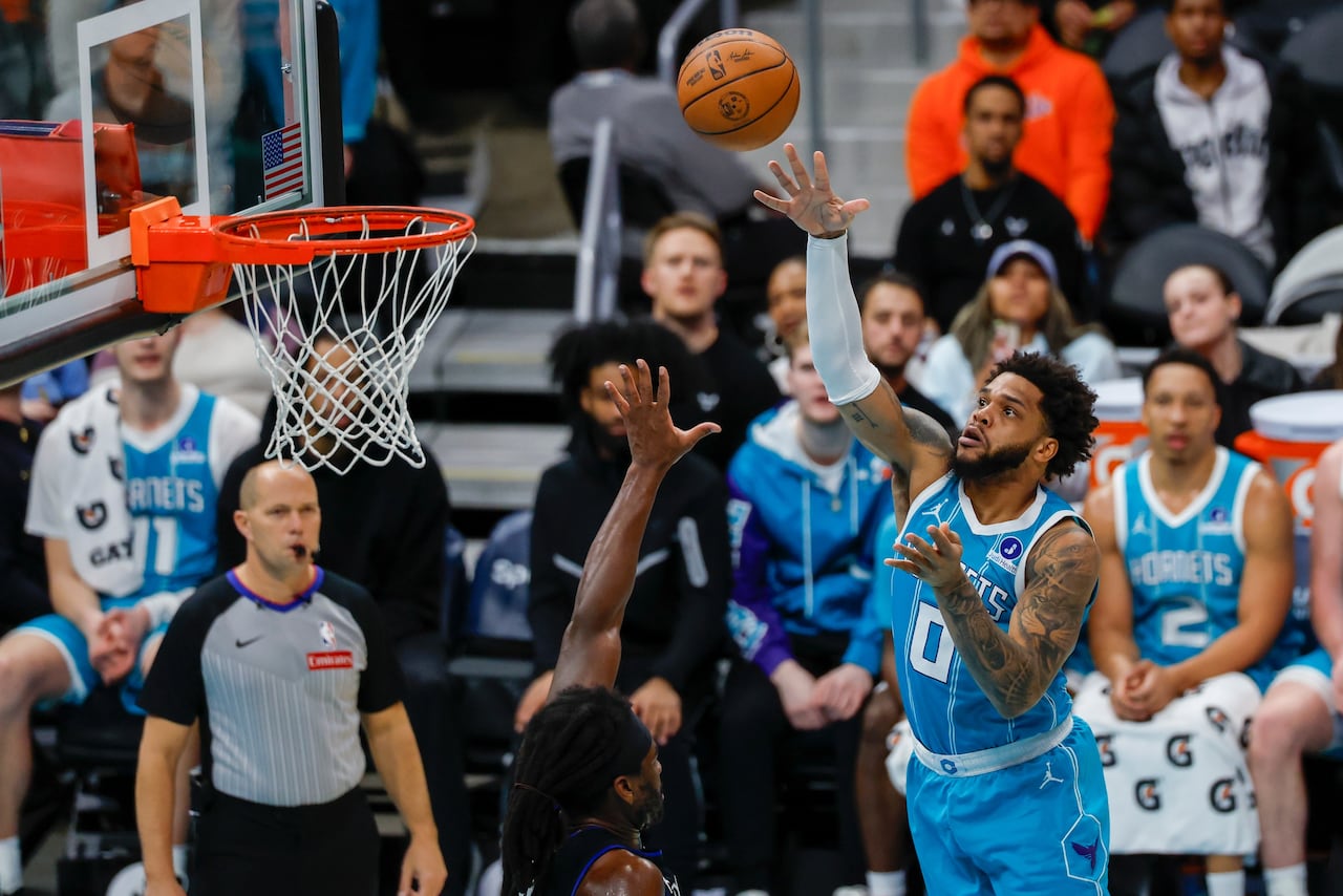 Charlotte Hornets forward Miles Bridges (0) shoots against Detroit Pistons forward Isaiah Stewart, center, during the first half of an NBA basketball game in Charlotte, N.C., Monday, Feb. 9, 2026.