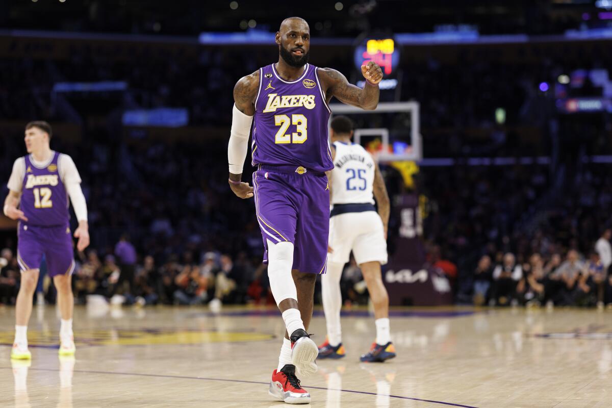 LeBron James reacts after sinking a three-pointer against the Mavericks in the first half.