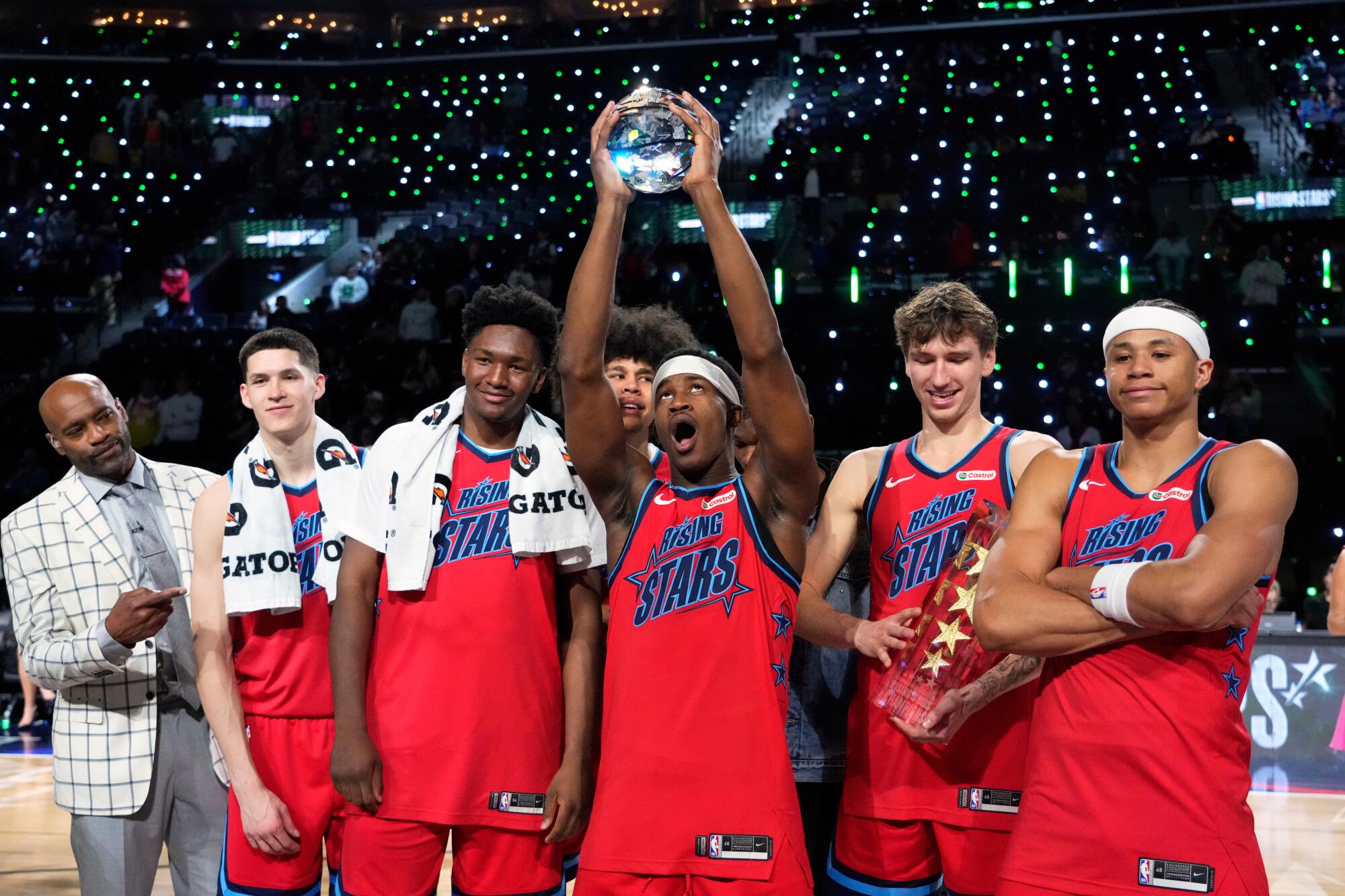 Members of Team Vince hold up their trophies after they defeated Team Melo in a final in NBA Rising Stars Challenge.