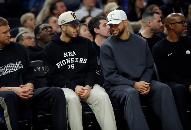 Golden State Warriors' Stephen Curry #30 and his brother Seth Curry, #31 left, sit on the bench in the third quarter of their NBA game against the Memphis Grizzlies at the Chase Center in San Francisco, Calif., on Monday, Feb. 9, 2026. (Jane Tyska/Bay Area News Group)