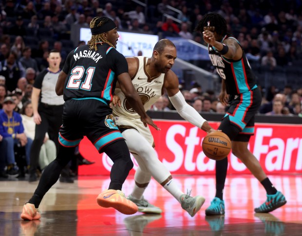 Golden State Warriors' Al Horford #20 is guarded by Memphis Grizzlies' Jahmai Mashack #21 and Brandon Clarke #15 in the first quarter of their NBA game at the Chase Center in San Francisco, Calif., on Monday, Feb. 9, 2026. (Jane Tyska/Bay Area News Group)