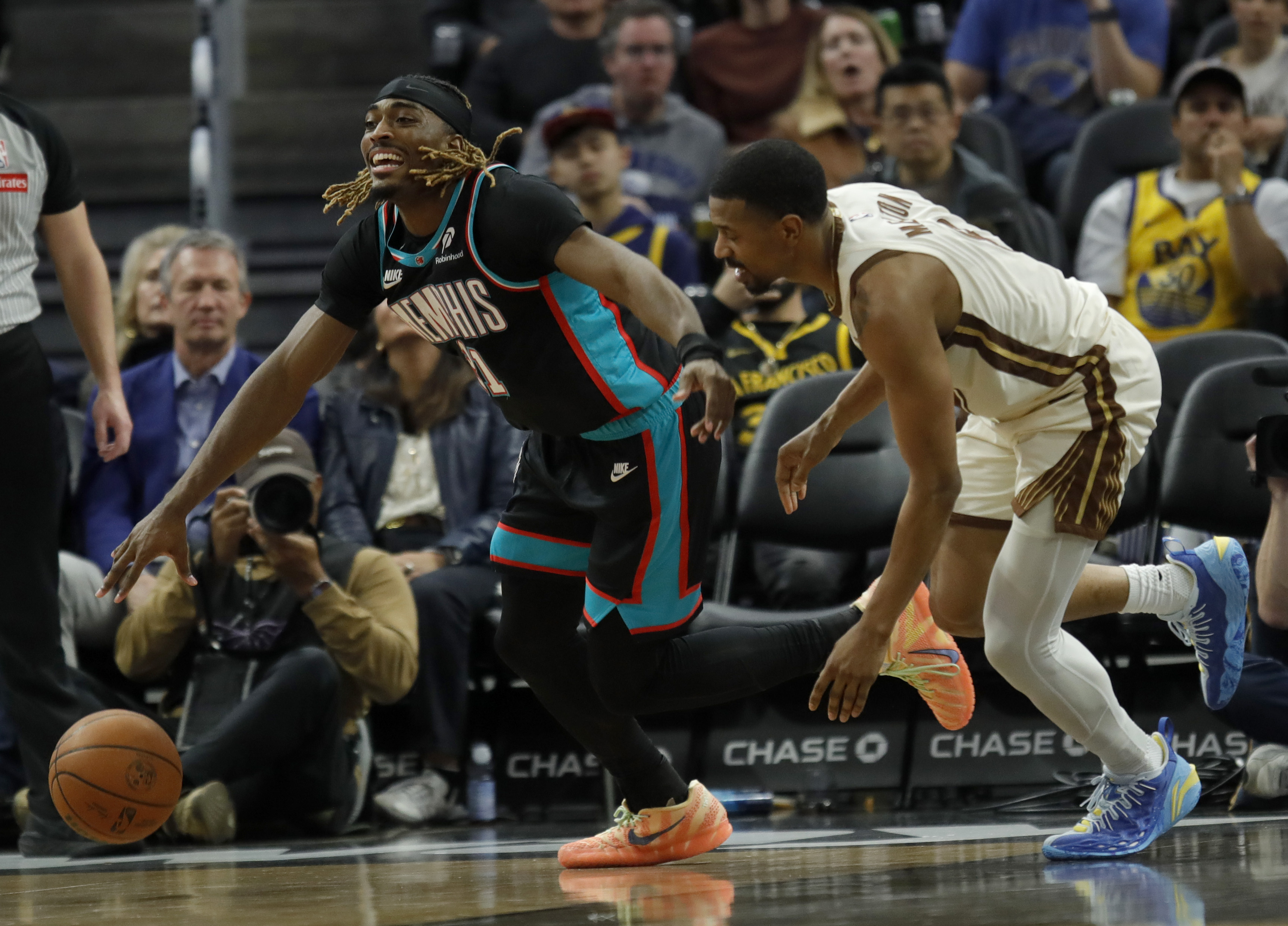 Memphis Grizzlies' Jahmai Mashack #21 is guarded by Golden State...