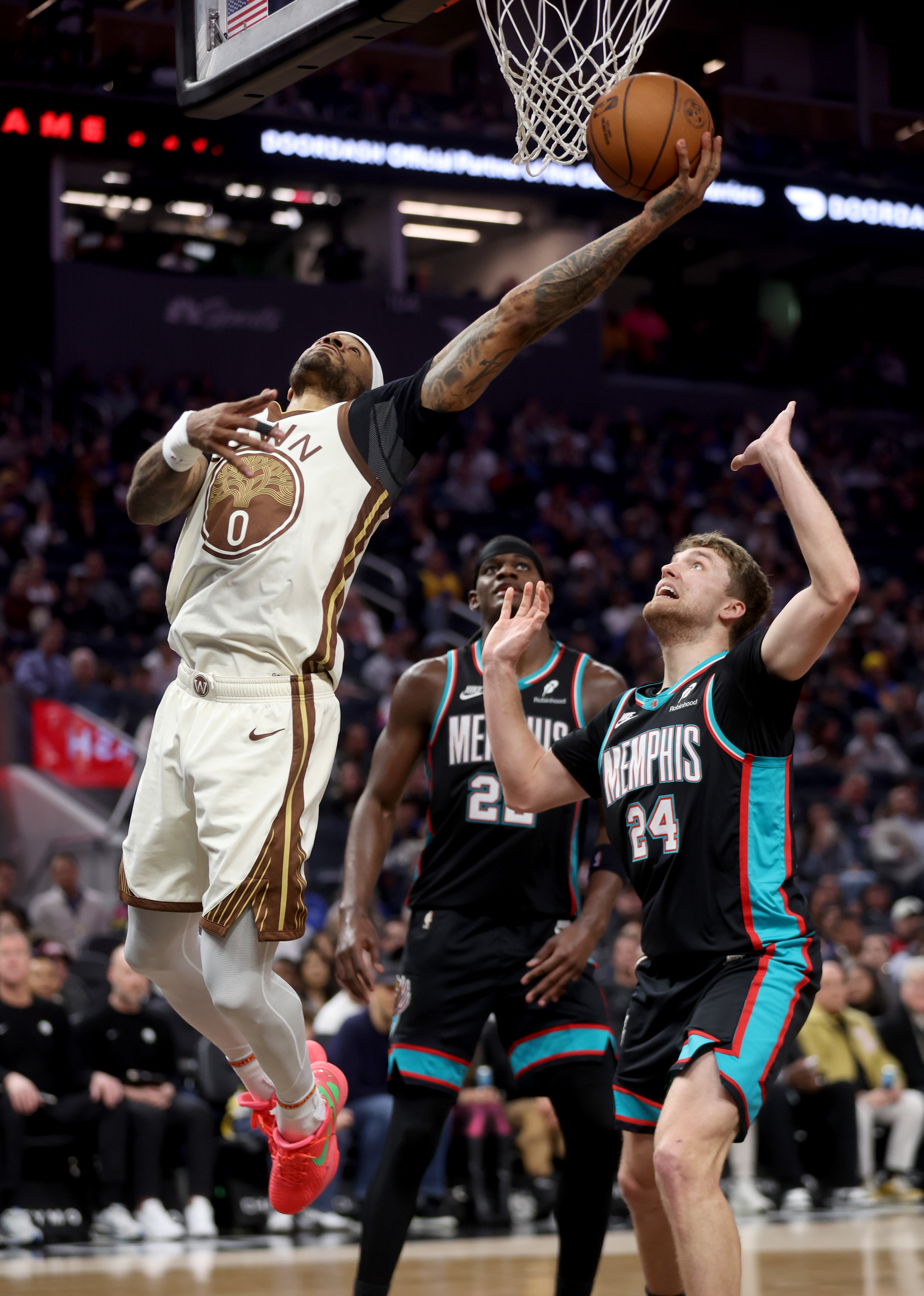 Golden State Warriors' Gary Payton II #0 shoots a layup...