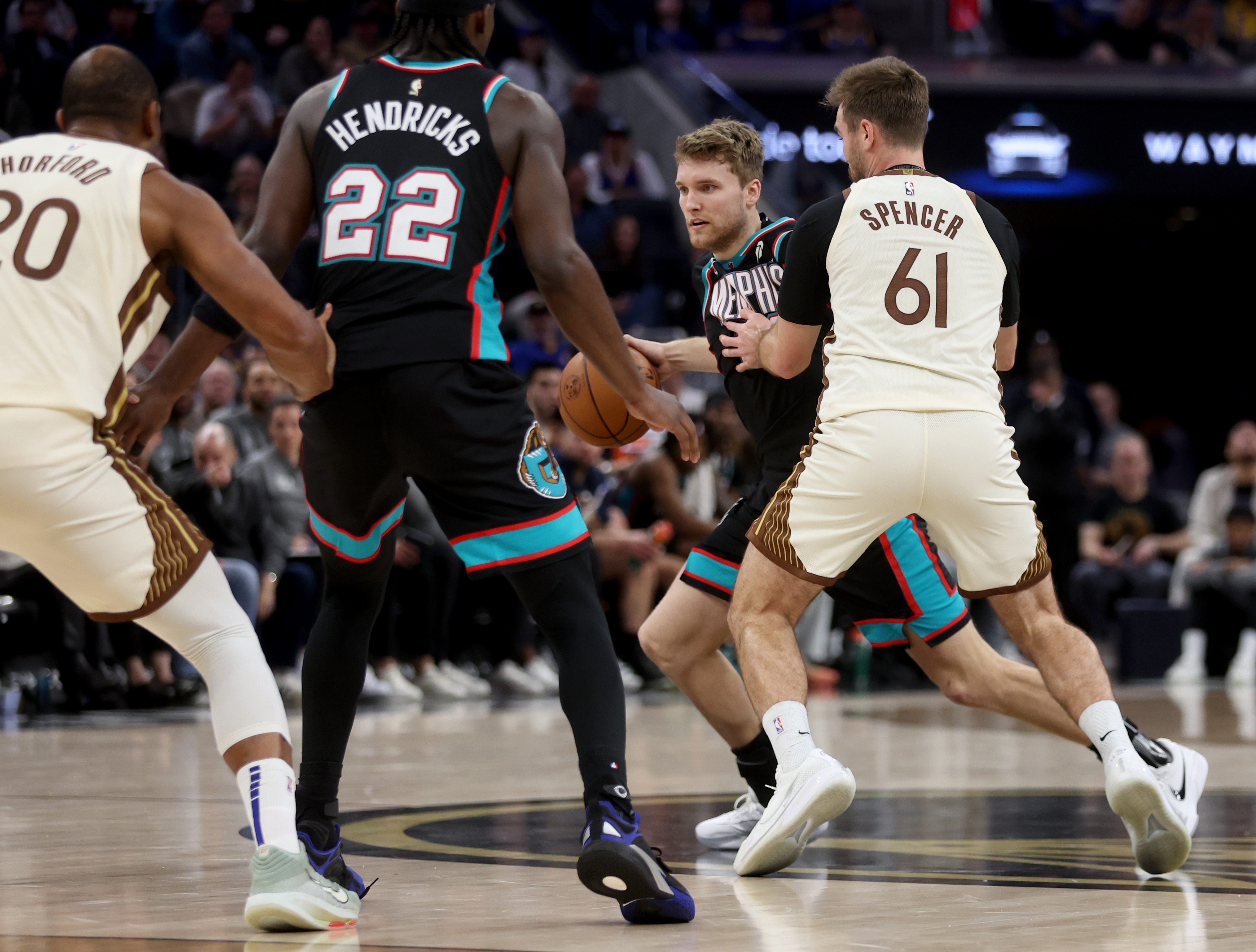 Memphis Grizzlies' Cam Spencer #24 is guarded by his brother...