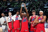 Members of Team Vince hold up their trophies after they defeated Team Melo in a final in NBA...