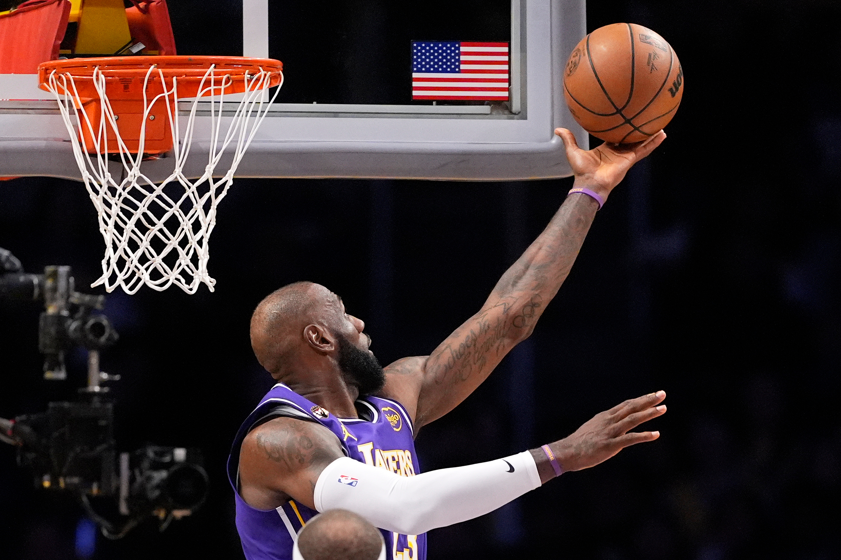 Lakers forward LeBron James shoots a reverse layup during the...