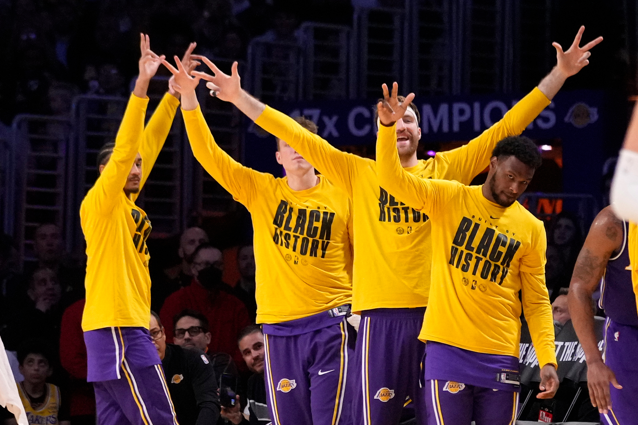 Members of the Lakers, including guard Bronny James, right, celebrate...