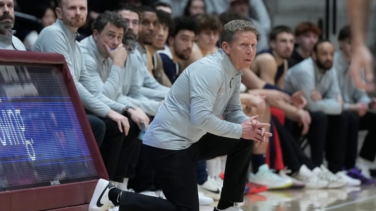 Gonzaga head coach Mark Few, middle, watches from the sideline...