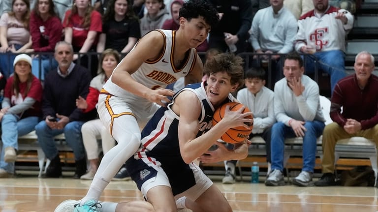 Gonzaga guard Davis Fogle, bottom, holds onto the ball under...