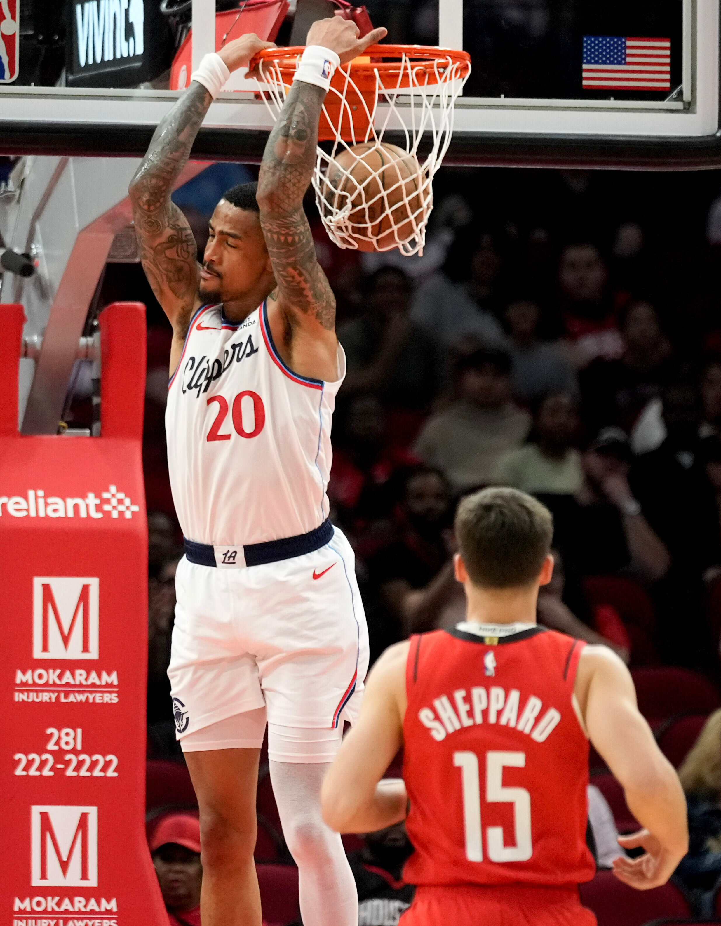 Clippers forward John Collins dunks during the first half of...
