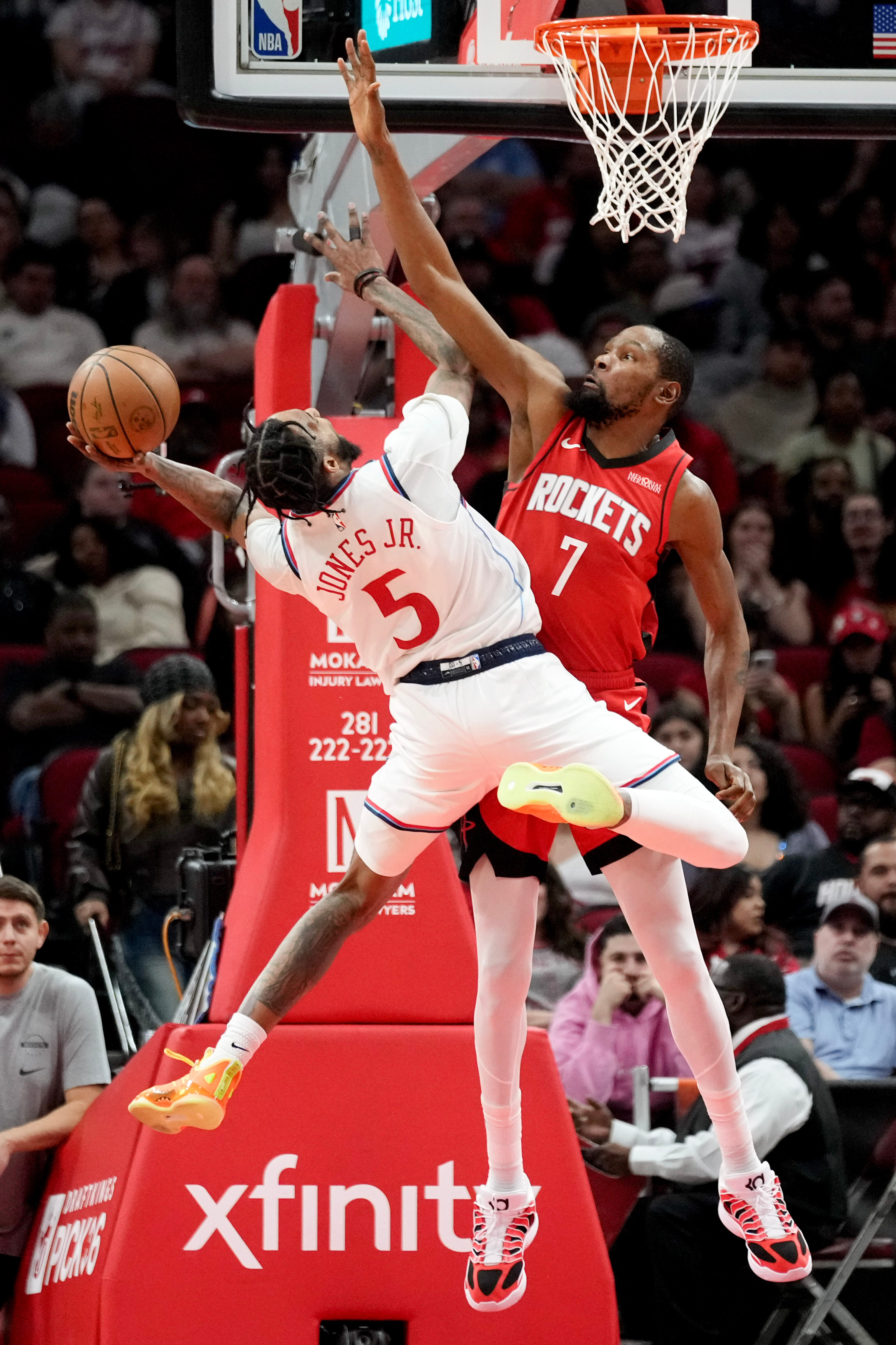 Clippers forward Derrick Jones Jr., left, shoots as Houston Rockets...